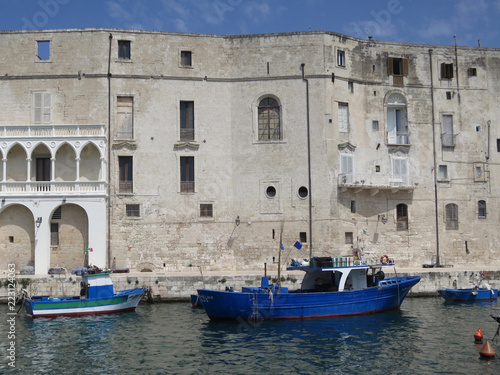 facade and quay in Polignano a Mare with boats and fishing gear © Moniek