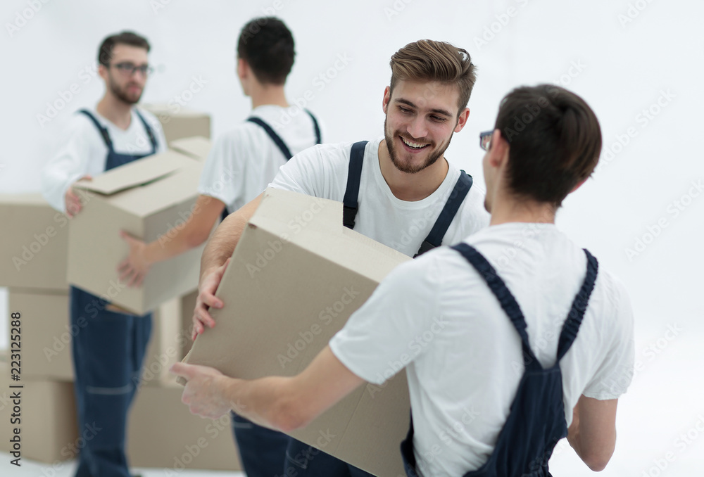 Portrait of movers holding box smiling isolated on white backgro Portrait of movers holding box smiling isolated on white backgro