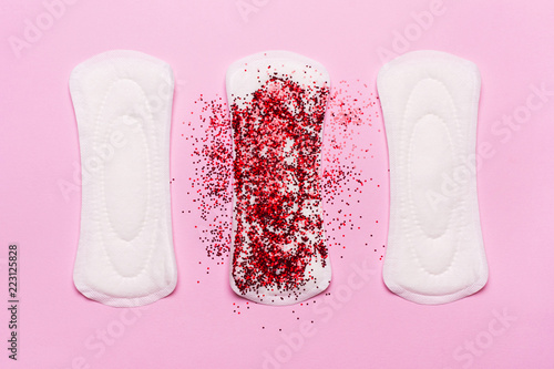 Women's hygiene products on a pink background. Concept of critical days,  menstruation photo