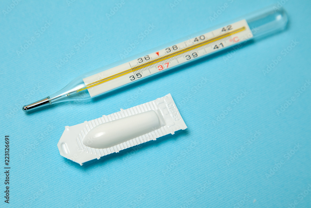 Suppository for anal or vaginal use and thermometer. Candles for treatment  of high temperature Stock Photo | Adobe Stock