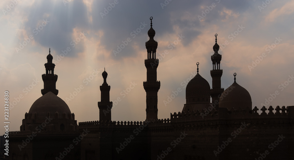 Silhouette shot of minarets and domes of  Sultan Hasan mosque and Al Rifai Mosque, Old Cairo, Egypt