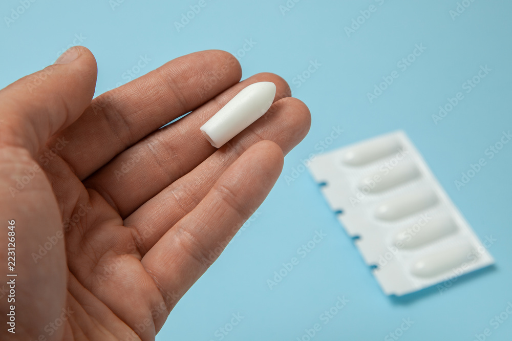 Suppository for anal or vaginal use in the hands of a man. Candles for  treatment of hemorrhoids, temperature, thrush Stock Photo | Adobe Stock