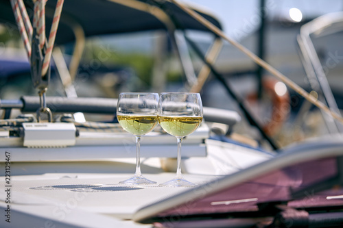 Pair of wineglasses against the yacht