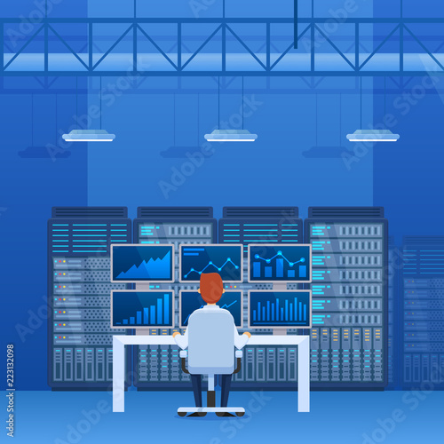 Interior of server room, employee working for computers and monitors.