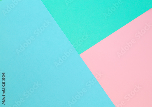 Triangle. Blue, pink and light green color paper background. Image with space for text.