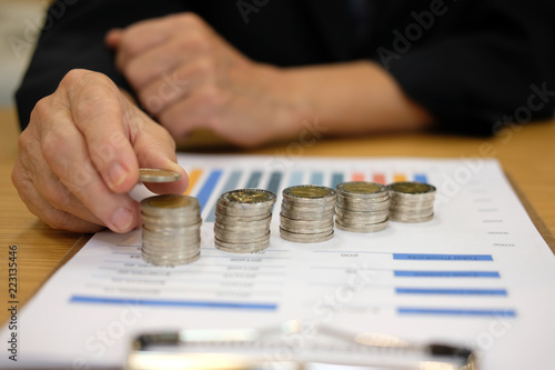hand put coin on pile. money savings, cash deposit concept