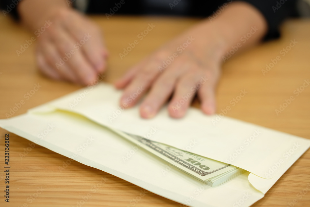 woman offer envelope with money banknote. hand giving cash banknote. bribery, corruption, venality concept woman offer envelope with money banknote. hand giving cash banknote. bribery, corruption, venality concept