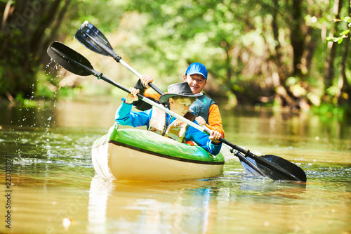 Fotografie Kayaking on river in forest