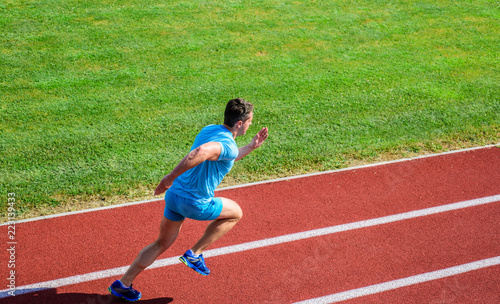 Athlete run track grass background. Runner in motion. Many runners like challenge of extending their endurance without having to do training necessary to finish marathon. Man athlete run training