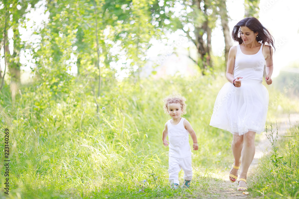 Mother and son having fun running together at the patk