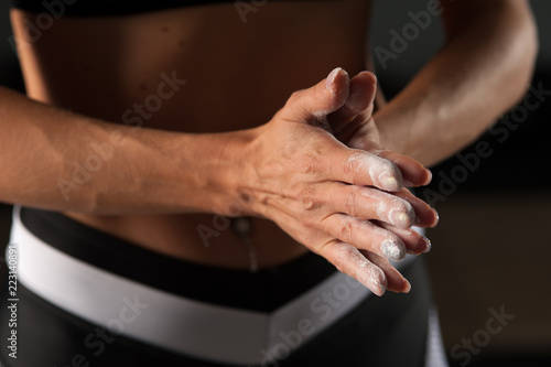 Closeup of female hands with chalk powder. © pavel_shishkin