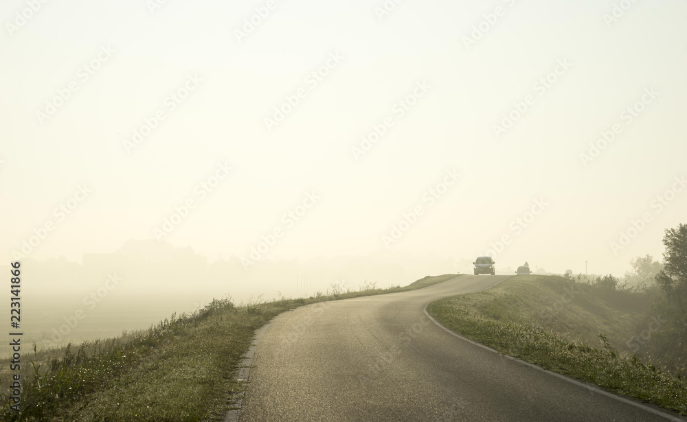car on the county road with fog