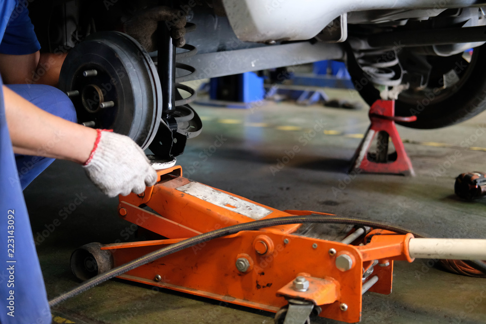 mechanic replace shock absorber & spring in auto repair garage mechanic replace shock absorber & spring in auto repair garage