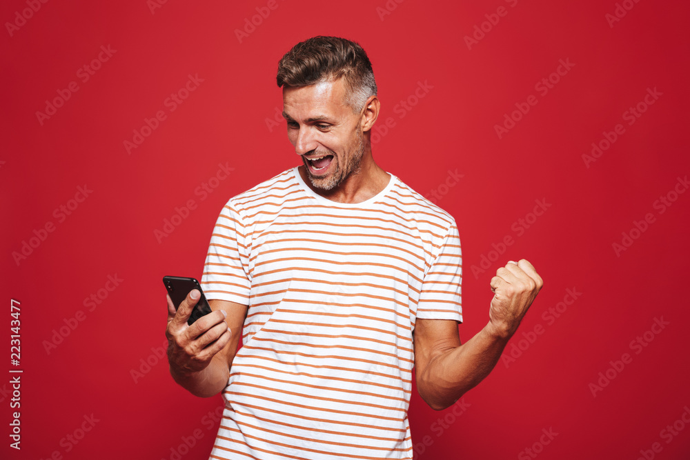 Portrait of a smiling man standing over red background Portrait of a smiling man standing over red background