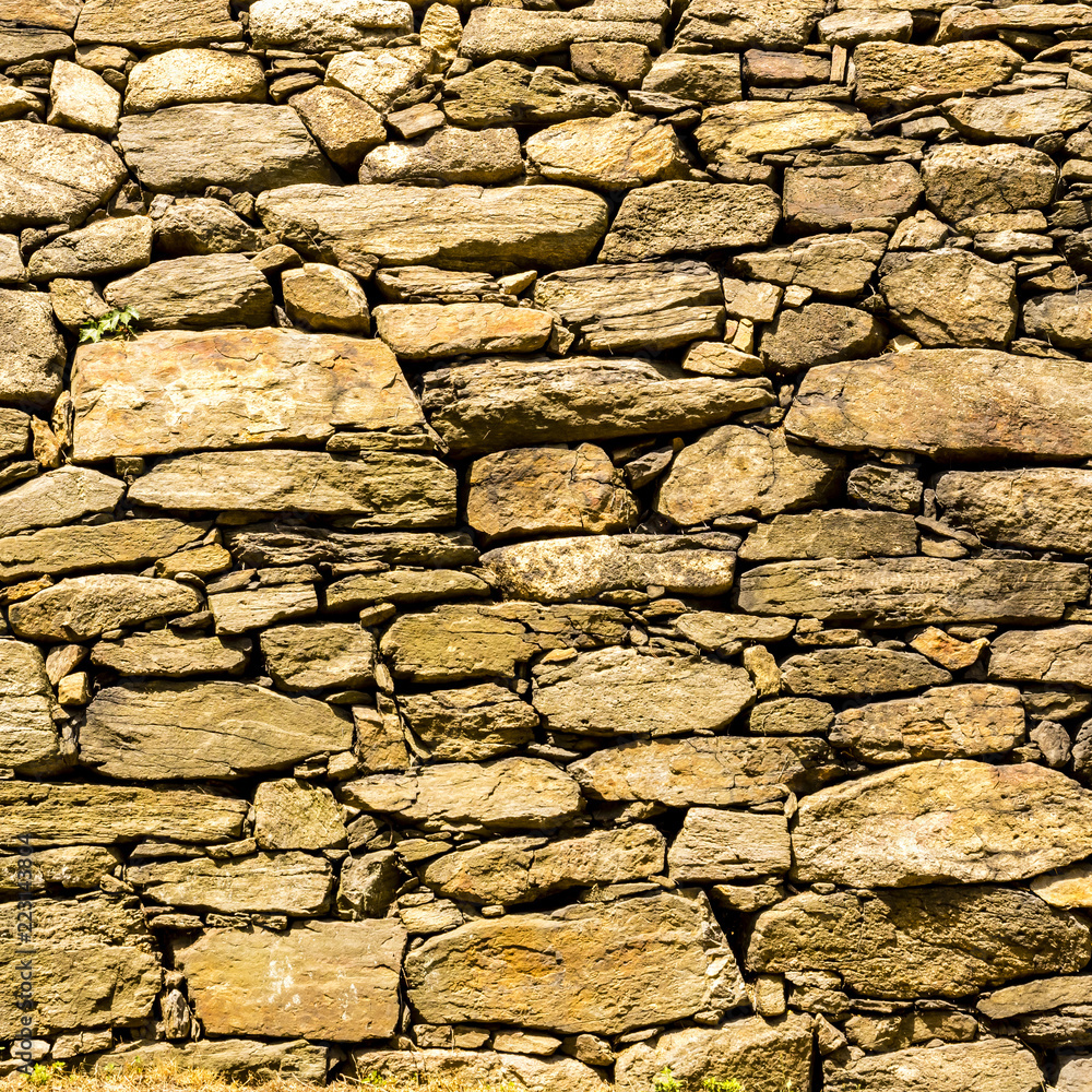 Rough old wall background, part of stone masonry