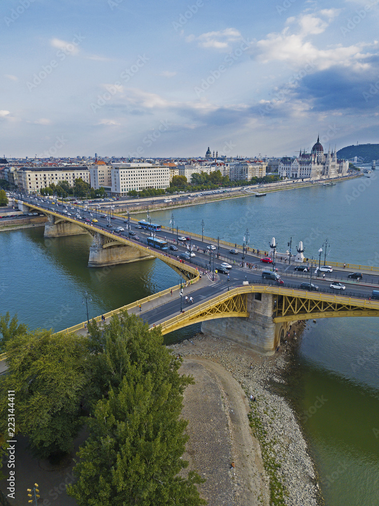 Aerial view of Margaret Bridge over the Danube river with the Parliament building and the downtown of Budapest, Hungary