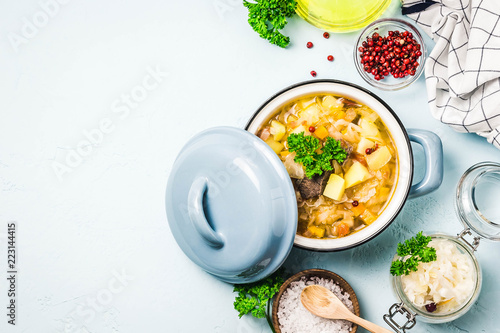 Traditional sauerkraut soup, shchi with meat and vegetables. Top view, space for text.