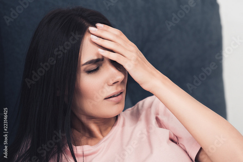 close-up shot of young woman suffering from headache