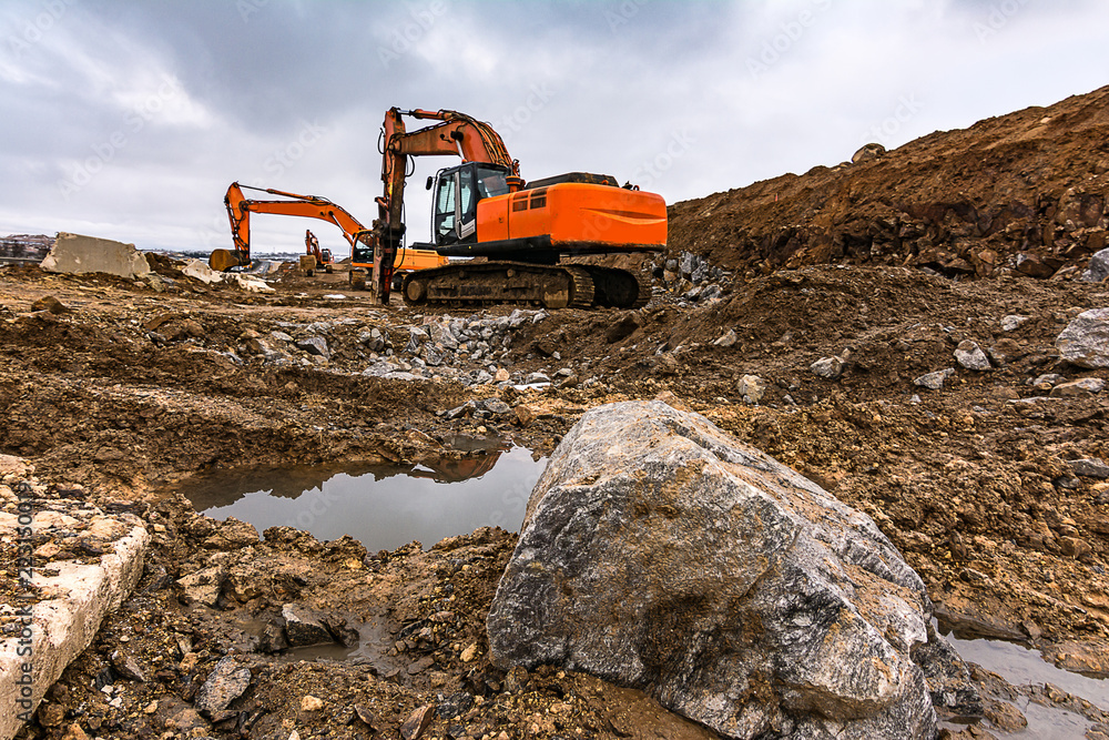 Works in the construction of a road extracting stone in a hard day of winter work Works in the construction of a road extracting stone in a hard day of winter work