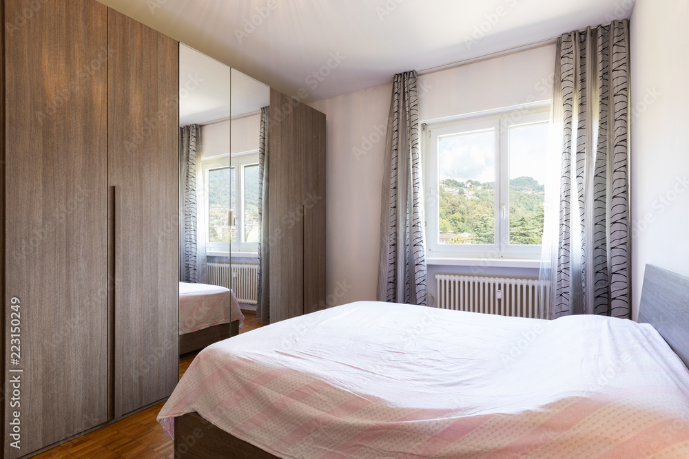 Bedroom with parquet and window with view Bedroom with parquet and window with view