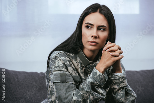 Konstfotografi Close-up portrait of thoughtful female soldier in military uniform with ptsd sit