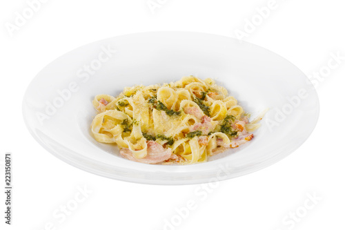 Pasta, noodles with bacon and sauce pesto, decorated with cheese. Side view. Serving a meal in a cafe, restaurant. Isolated white