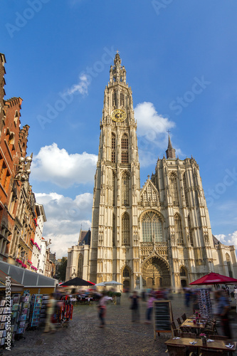 Beautiful wide angle view of the Cathedral of Our Lady (Onze-Lieve-Vrouwekathedraal) seen from the Handschoenmarkt in Antwerp, Belgium, on a summer day with a blue sky
