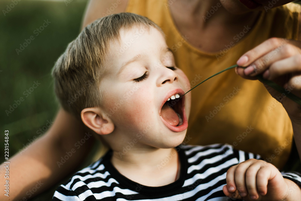 portrait of a little boy playing with his mom portrait of a little boy playing with his mom