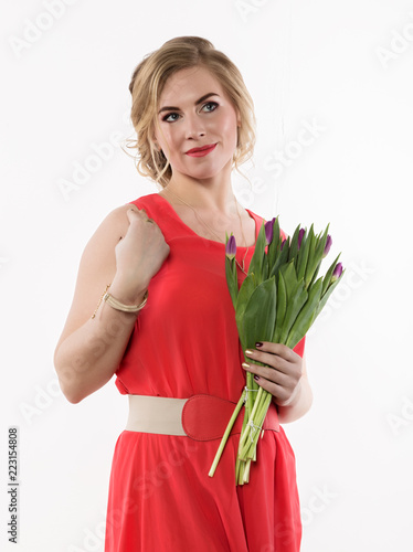 beautiful woman with flowers tulips on a light background photo