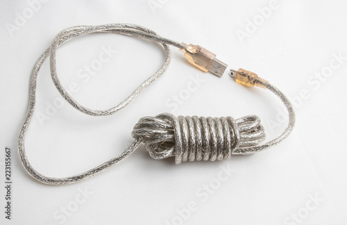 transparent usb wire wound in a hank on a white background, isolate