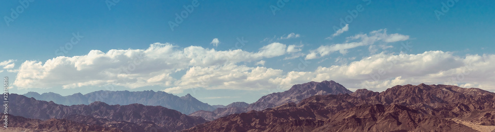 Landscape of mountain peaks at cloudy sky Landscape of mountain peaks at cloudy sky