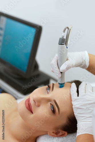 Face Skin Care. Closeup Of Woman Face Cleansing At Cosmetology