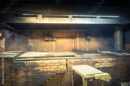 Vintage tone empty pit room at a traditional Texas style BBQ Meat Market. Smoke house with indirect-heat pit and gas-fired smoker. Old fashioned slow cooked in family meat market, La Grange, TX, US photo