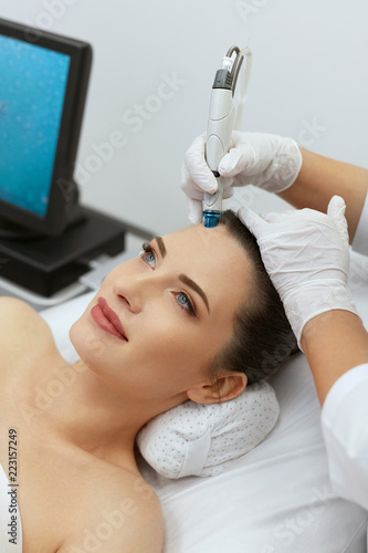 Face Skin Care. Closeup Of Woman Face Cleansing At Cosmetology photo