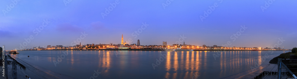 Beautiful cityscape panorama of the skyline of Antwerp, Belgium, during the blue hour seen from the shore of the river Scheldt
