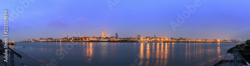 Beautiful cityscape panorama of the skyline of Antwerp, Belgium, during the blue hour seen from the shore of the river Scheldt