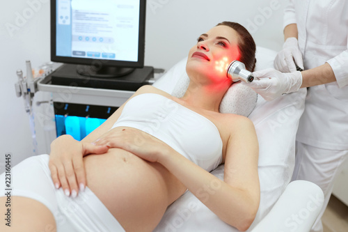 Quadro su tela Cosmetology. Pregnant Woman Doing Red Light Therapy At Clinic