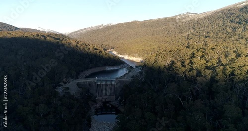 Australian hydro scheme and concrete dam on Snowy river near Guthega forming water reservoir between slopes of mountain ranges.
 photo