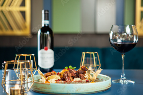 Delicious breast duck with mash potato and red wine on the table. Fine cuisine