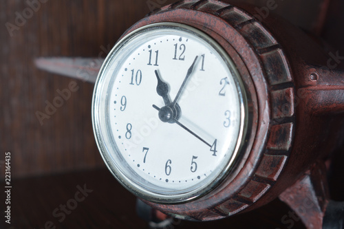 Wallpaper Mural a wooden clock-plane of a dark-colored tree stands on a wooden shelf Torontodigital.ca