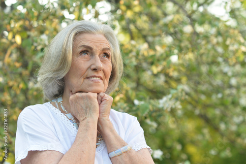 beautifil elderly woman posing in autumn park