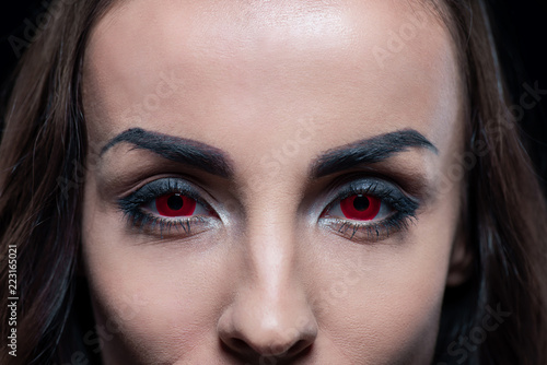 cropped view of demon with red eyes photo