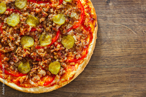 Pizza with Mozzarella cheese, minced meat and vegetables. Italian pizza on wooden background. with copy space. top view