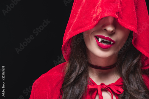 vampire woman in red cloak isolated on black