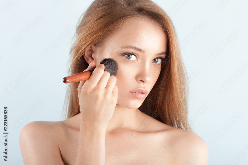 Young beautiful girl with brush for powder close-up Young beautiful girl with brush for powder close-up