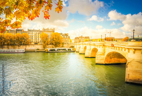 Pont Neuf and river Seine waters, blue fall sky with clouds, Paris, France