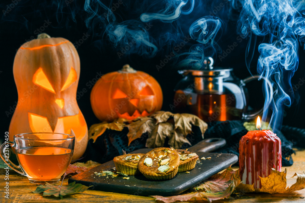 Halloween photo of table with pumpkin, biscuit, burning candle