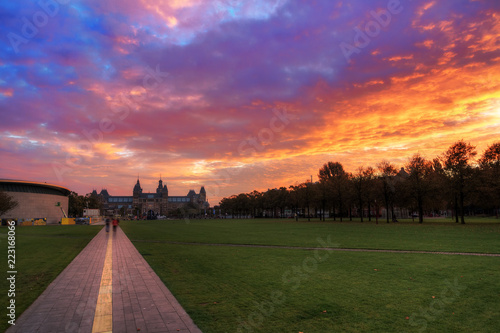 Amazing vibrant sunrise at the Museum Square (Museumplein) in Amsterdam, The Netherlands, looking towards the beautiful National State museum (Rijksmuseum) 