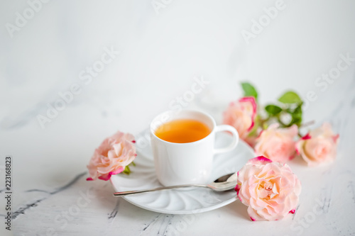 cup of tea with roses on a light background