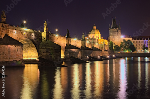 Summer night view of historical part of Prague. Vltava river, Mala Strana Bridge Tower and Charles Bridge with illumination. Prague, Czech Republic